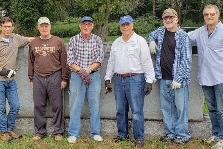 Brandeis Men's Club at Temple Israel in NJ cleaning the temple's cemetery section