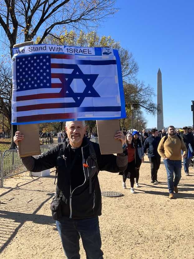 Member of Temple Israel holding an Israeli and American flag sign at the rally for Israel in Washington DC