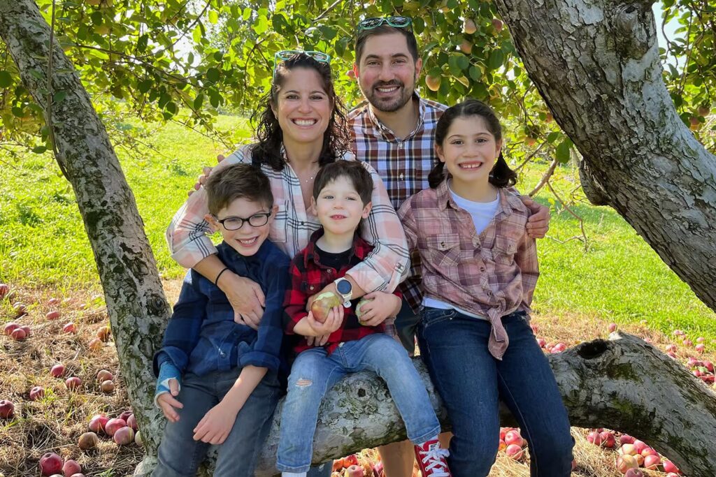 A family of five with Temple Israel membership participated in apple picking as part of early childhood activities.